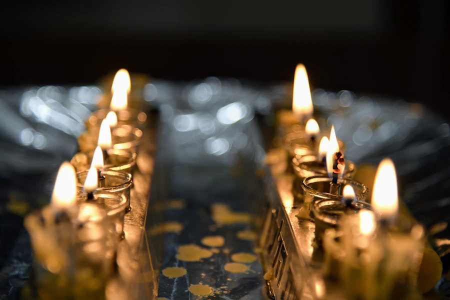 Rows of glowing menorah oil lights during Chanukah